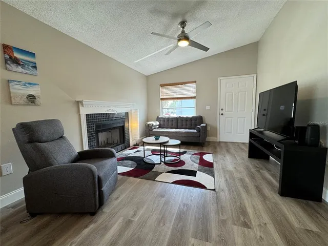 a living room with furniture and a fireplace