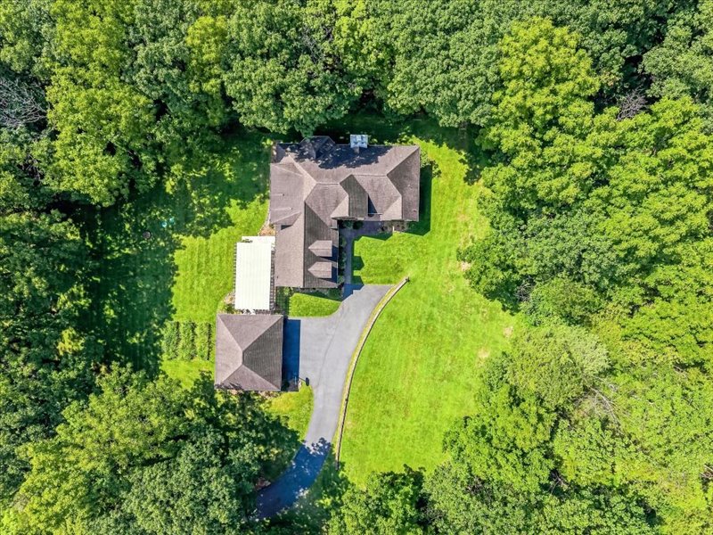 1168 Mt Pleasant Road Bangor, PA 18013 - Photo 10 of 100 Dense mature woodlands encircle a private country estate featuring a paved driveway and detached garage.
