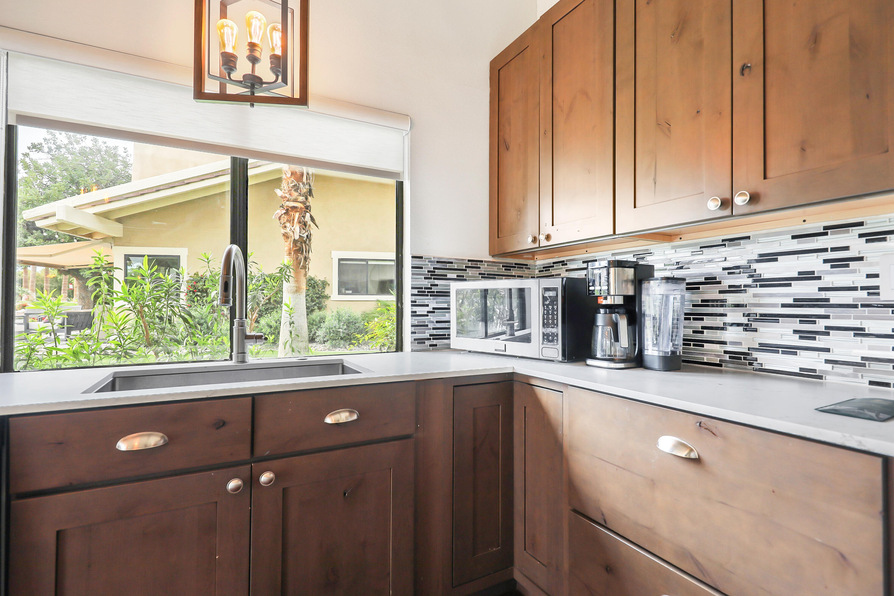 331 Red River Road Palm Desert, CA 92211 - Photo 11 of 56 a kitchen with stainless steel appliances a sink and cabinets