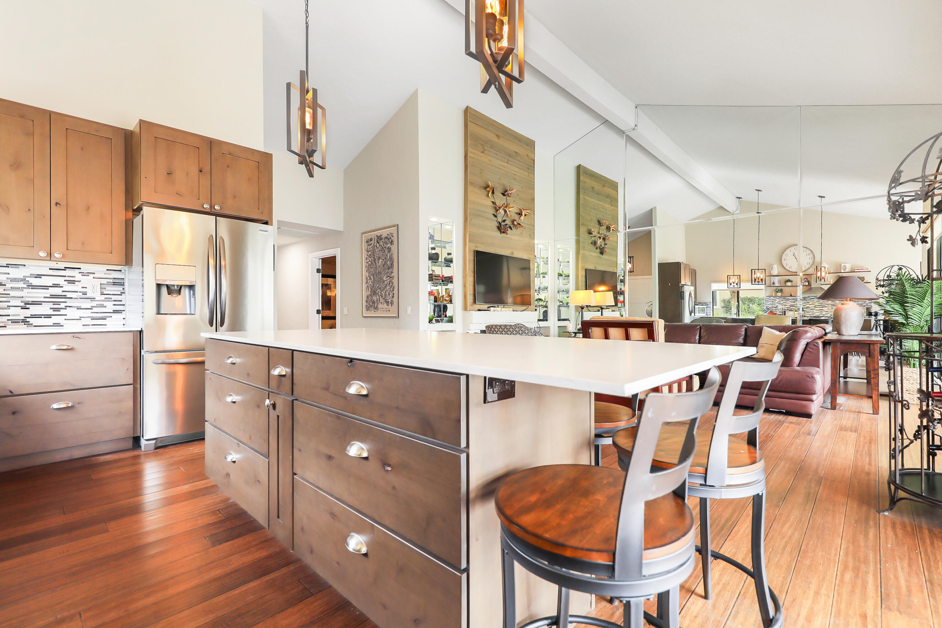 331 Red River Road Palm Desert, CA 92211 - Photo 13 of 56 a large kitchen with stainless steel appliances a stove a sink dishwasher and a dining table with wooden floor