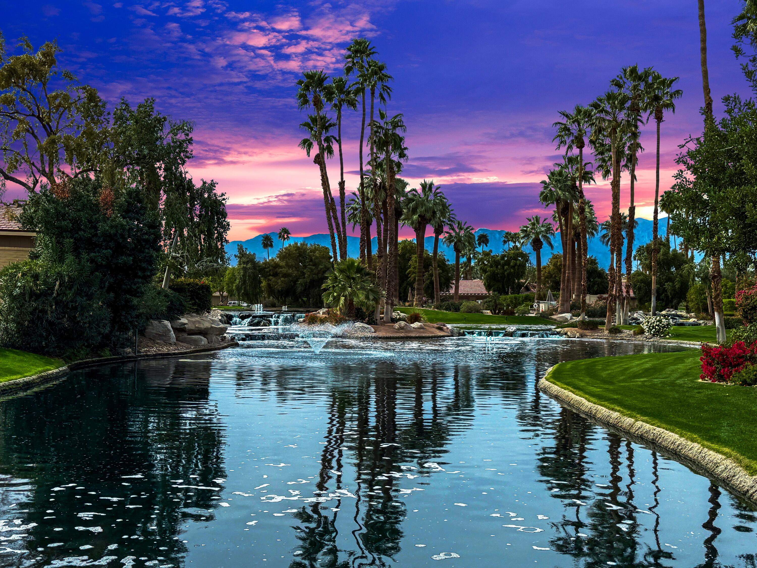 331 Red River Road Palm Desert, CA 92211 - Photo 2 of 56 a view of a lake with a house in the background