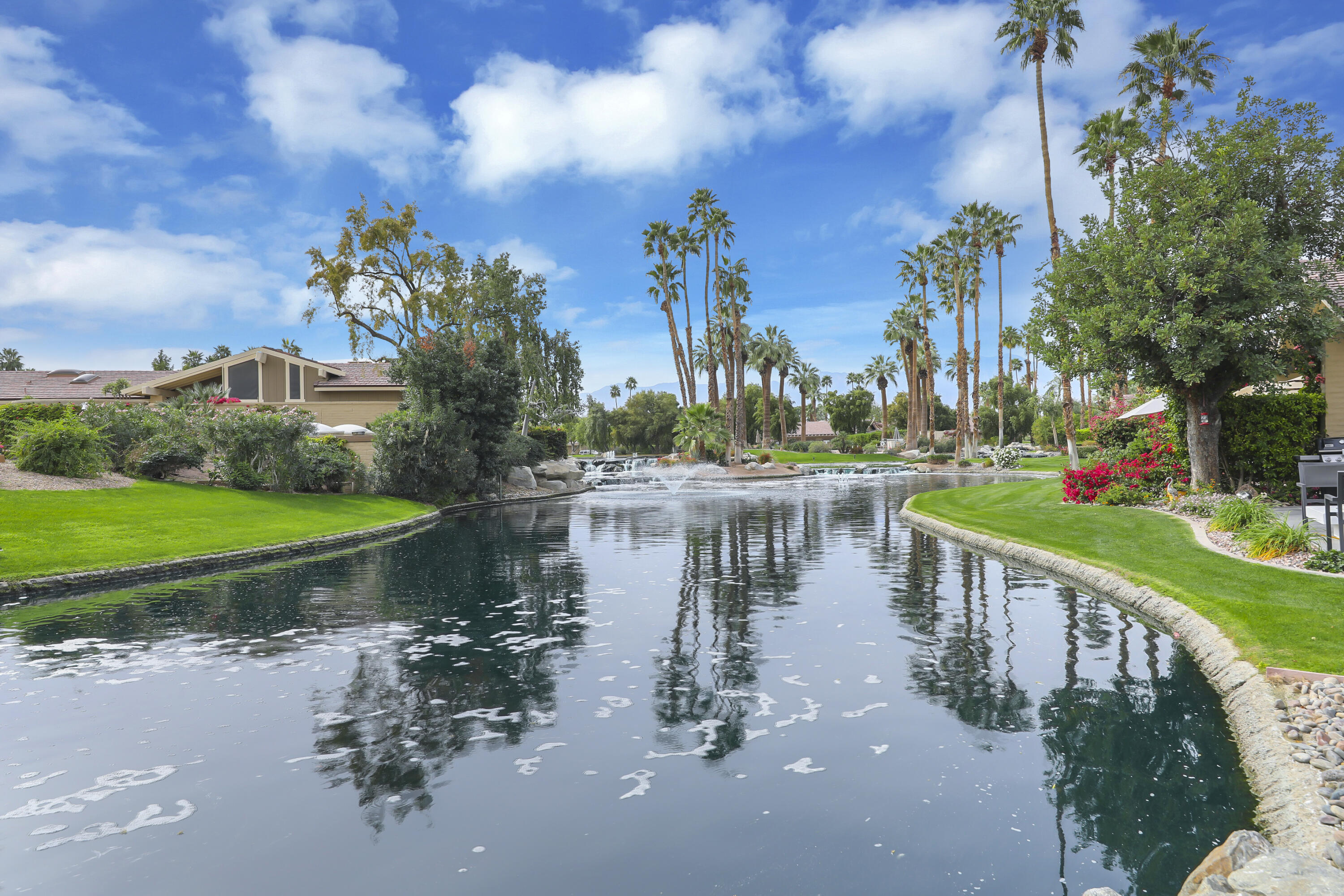 331 Red River Road Palm Desert, CA 92211 - Photo 28 of 56 a view of a lake with a house in the background