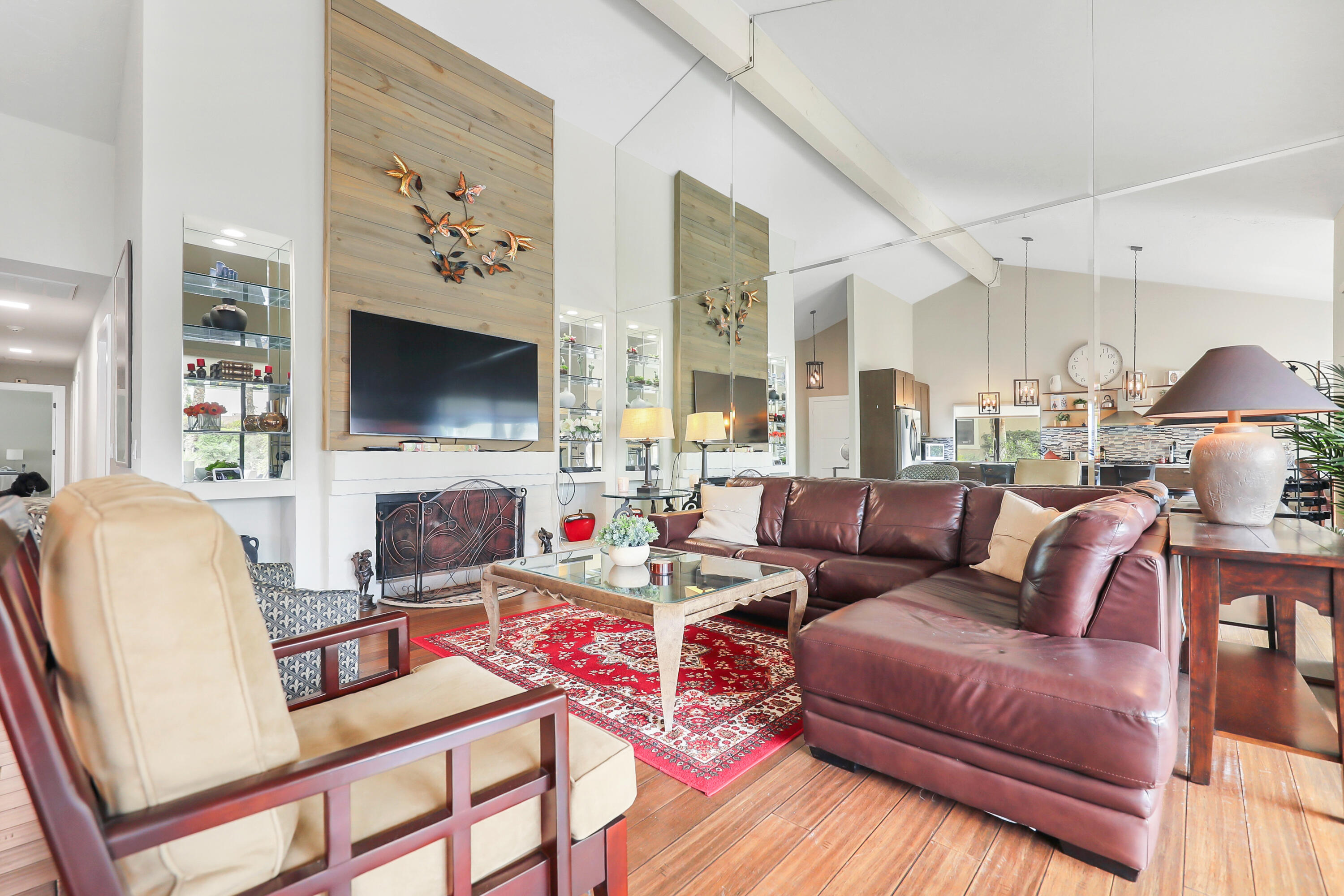 331 Red River Road Palm Desert, CA 92211 - Photo 6 of 56 a living room with furniture a flat screen tv and a fireplace