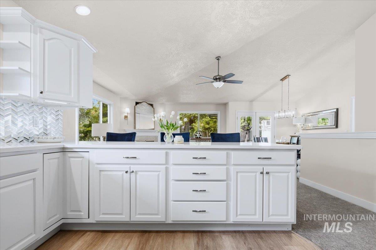 725 North Eagle Road Eagle, ID 83616 - Photo 11 of 45 Modern kitchen featuring white shaker cabinetry, an integrated dishwasher, and wood-finish flooring