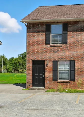 a front view of a house with a yard and a garage
