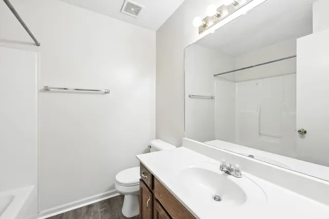 a bathroom with a sink toilet and mirror
