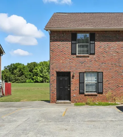 a front view of a house with a garden and garage