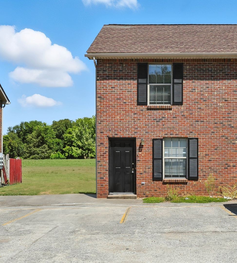 285 State Line Road Oak Grove, KY 42262 - Photo 17 of 18 a front view of a house with a garden and garage