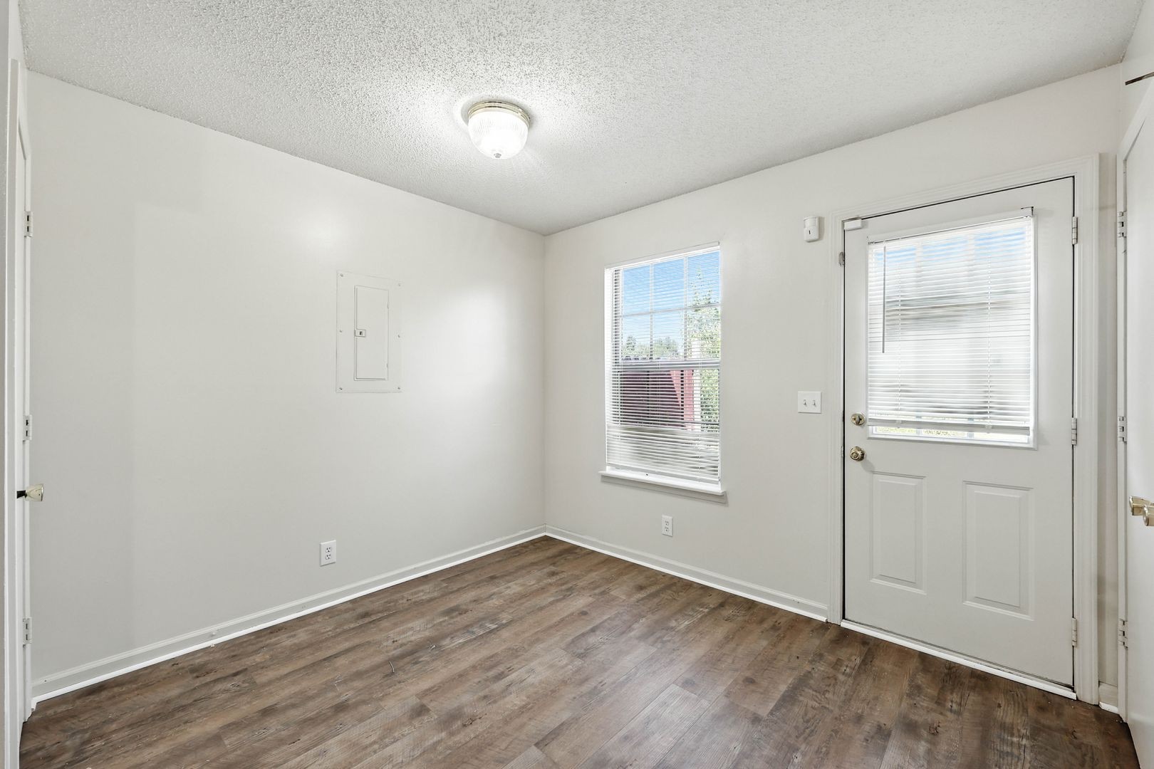 285 State Line Road Oak Grove, KY 42262 - Photo 7 of 18 an empty room with wooden floor and windows