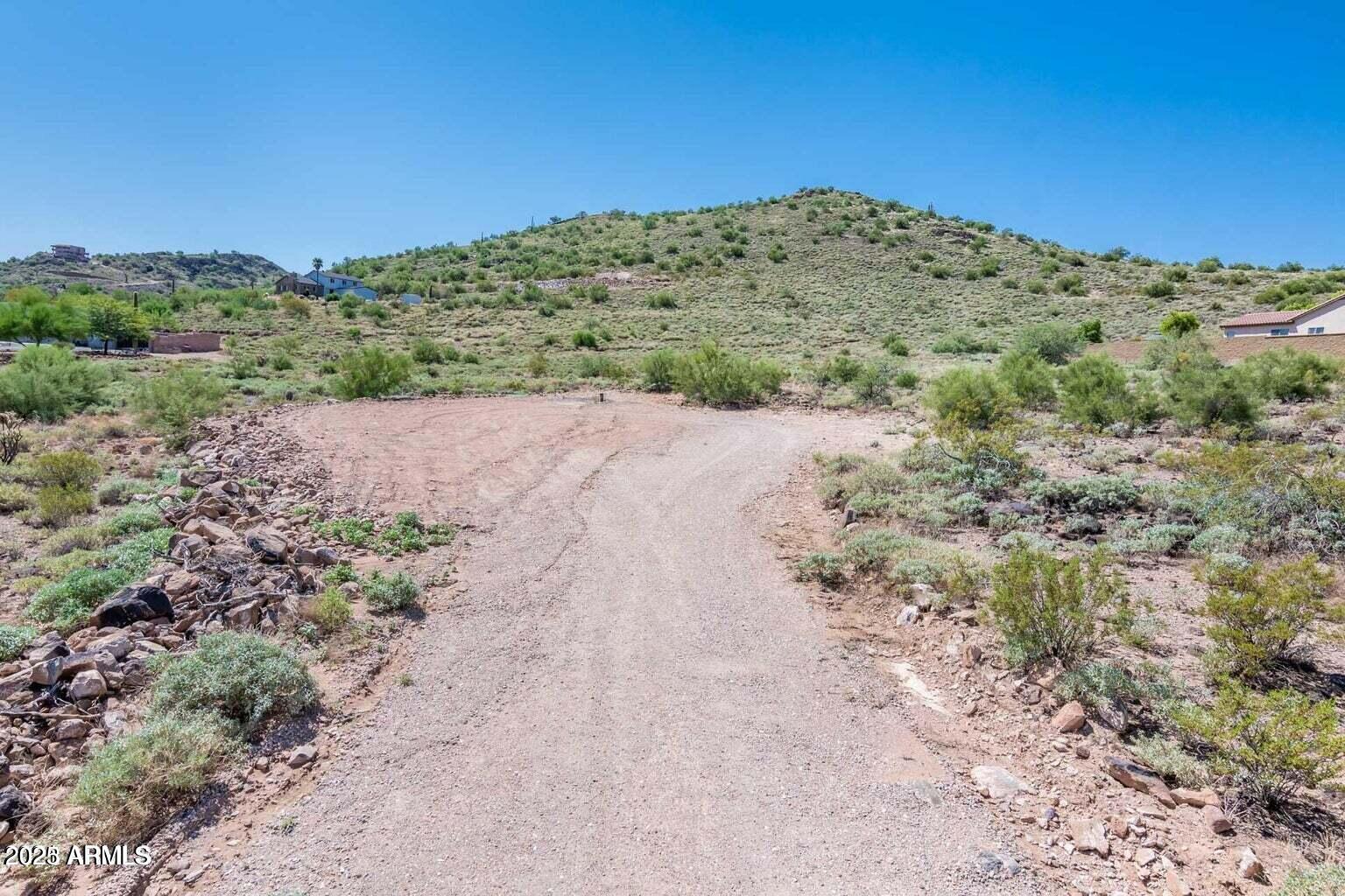 3451 West Irvine Road Phoenix, AZ 85086 - Photo 5 of 10 a view of a dry field with mountains in the background