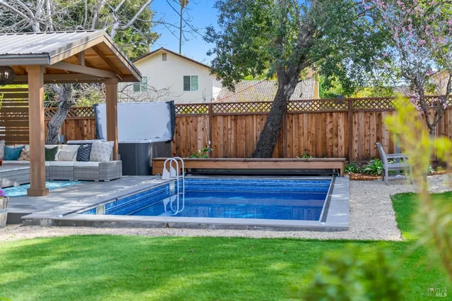 a living room with furniture kitchen view and a window