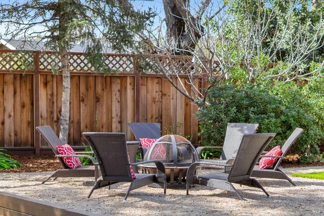 a view of a chairs and table in backyard