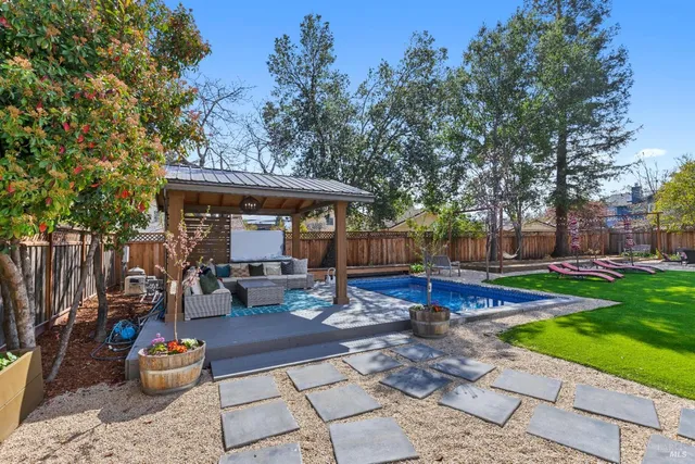 a view of a patio with table and chairs and potted plants