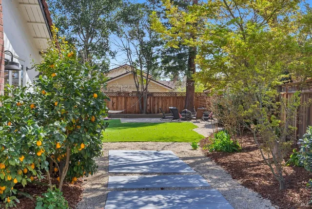 a bathroom with a granite countertop sink a toilet a mirror and shower