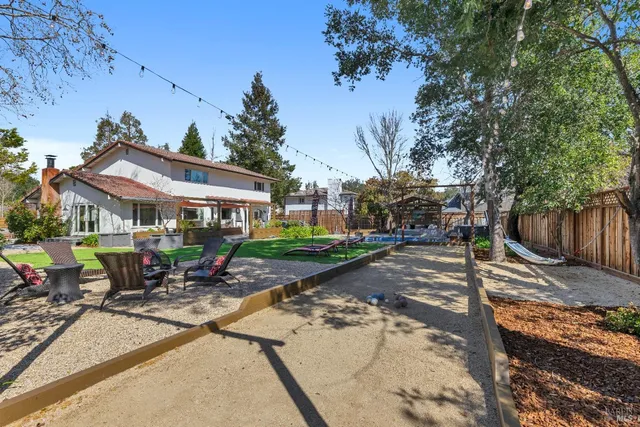 a living room with furniture a flat screen tv and a floor to ceiling window