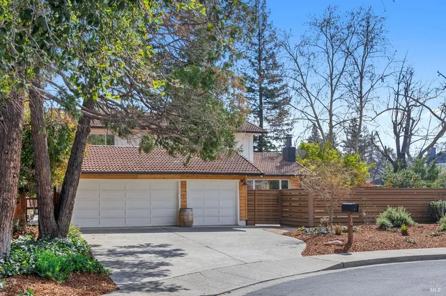 a view of a patio with a table and chairs under an umbrella