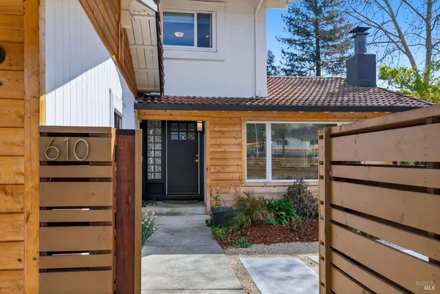 a view of a chairs and table in the back yard of the house