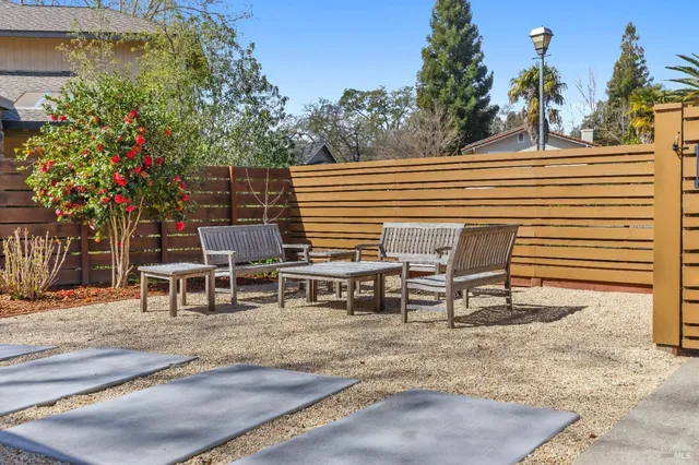 a dining room with a table chairs and a kitchen view
