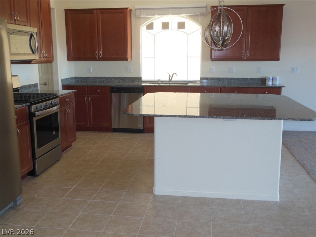 6390 Jackson Spring Road Las Vegas, NV 89118 - Photo 3 of 27 A well-appointed kitchen features ample cabinetry, granite counters, and modern appliances.