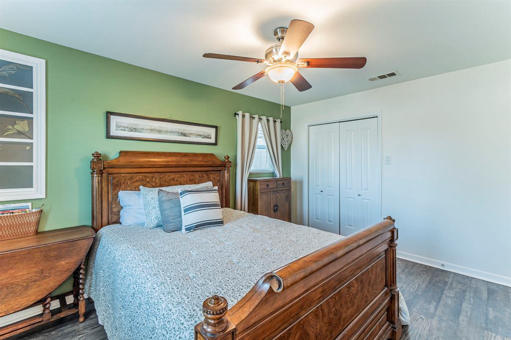 708 North Stewart Street Azle, TX 76020 - Photo 13 of 25 Bright primary bedroom with neutral finishes and peaceful views of the yard.