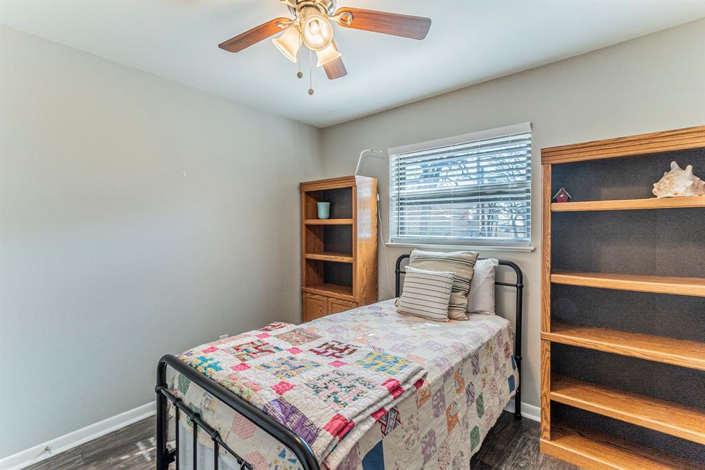708 North Stewart Street Azle, TX 76020 - Photo 19 of 25 Secondary bedroom with ample wall space and room for storage or shelving.