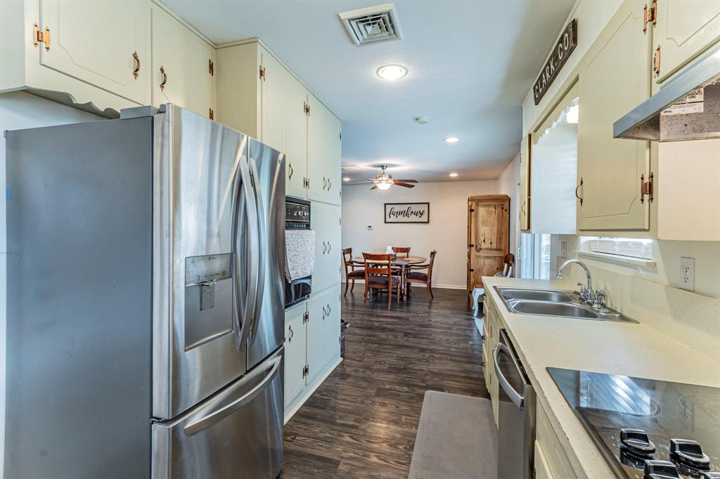 708 North Stewart Street Azle, TX 76020 - Photo 7 of 25 Functional kitchen layout with clear sightlines into the dining area for easy hosting.