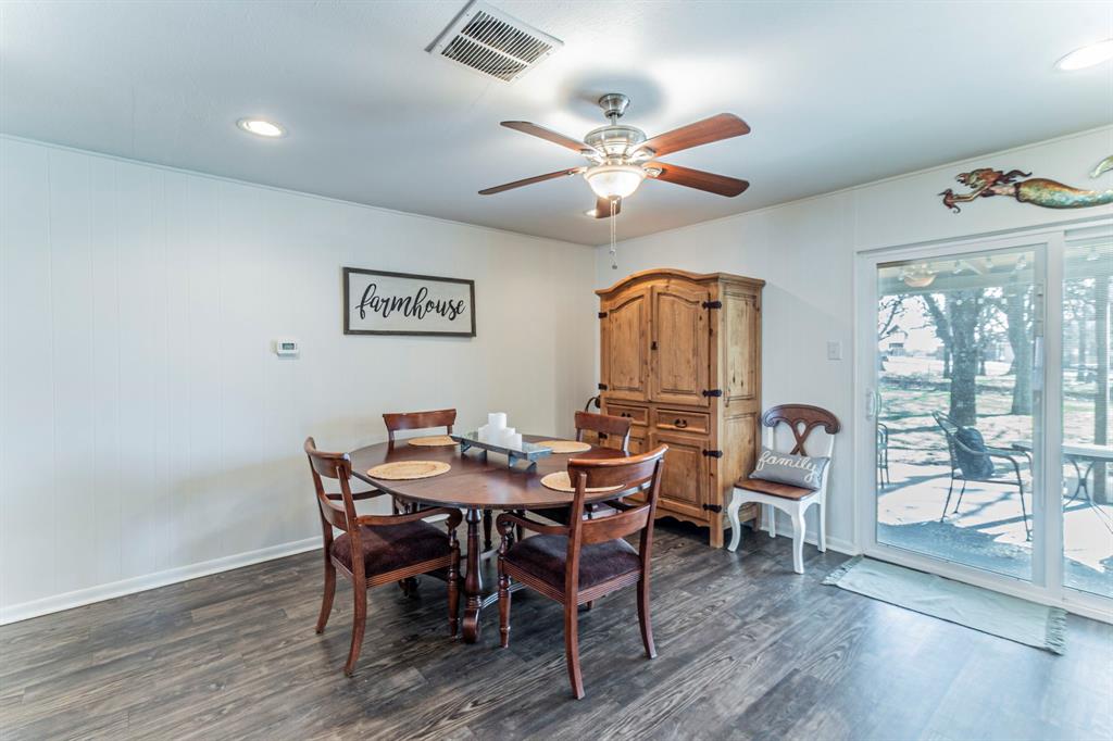 708 North Stewart Street Azle, TX 76020 - Photo 9 of 25 Open dining space with updated flooring and easy flow to the living area, perfect for gatherings.