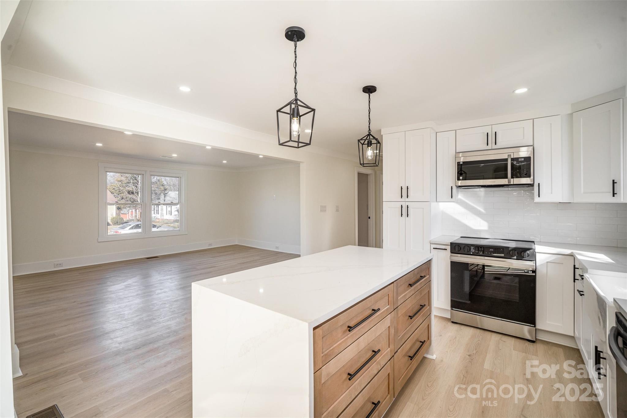 922 Grace Avenue Kannapolis, NC 28083 - Photo 11 of 27 a kitchen with stainless steel appliances granite countertop a stove a sink and a refrigerator