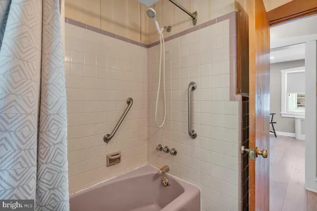 a bathroom with a bathtub and a shower