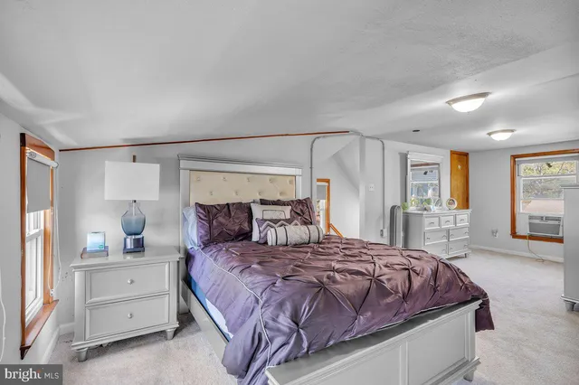 a bedroom with a large bed and a large window