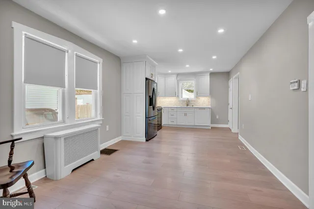 a view of a kitchen with refrigerator and window