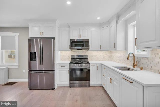 a kitchen with a sink stove and refrigerator