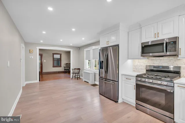 a view of kitchen with stainless steel appliances kitchen island granite countertop a stove and a refrigerator