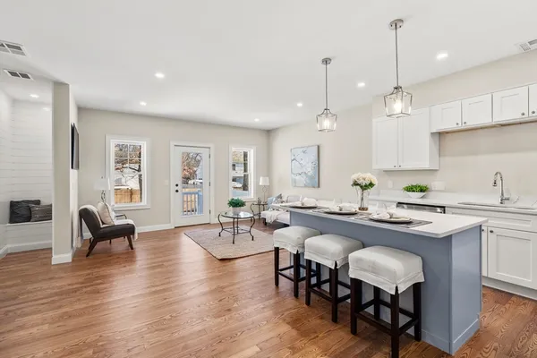 a open kitchen with sink cabinets and wooden floor