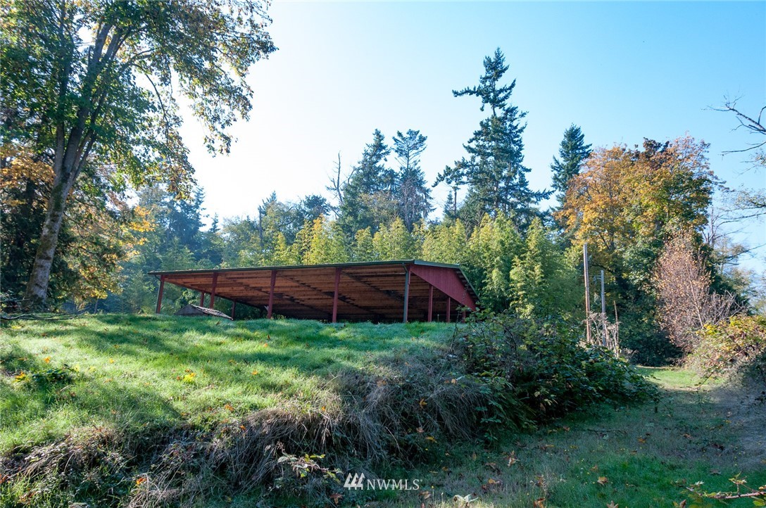 6765 Sills Road Clinton, WA 98236 - Photo 14 of 23 a view of a backyard with potted plants and large trees