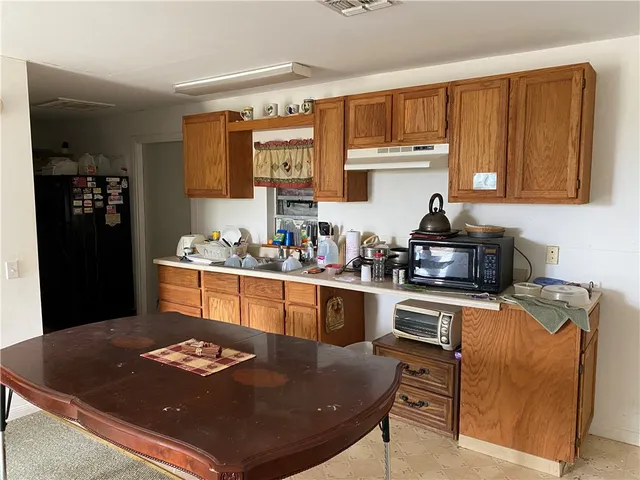 a kitchen with a table chairs stove and cabinets