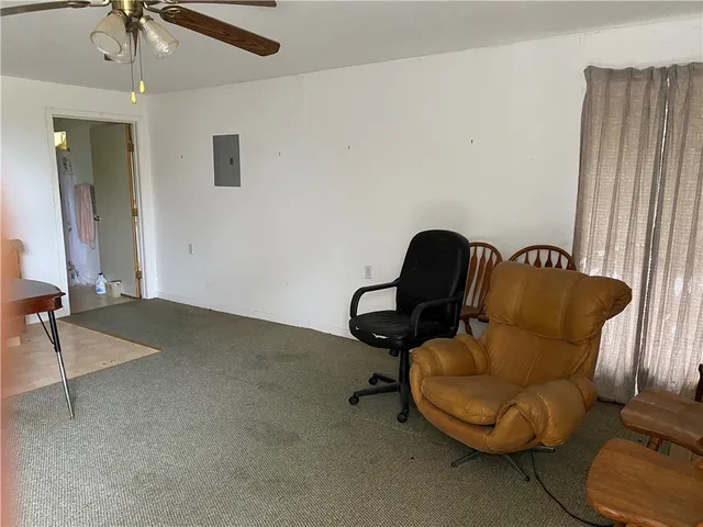 a living room with furniture and a chair