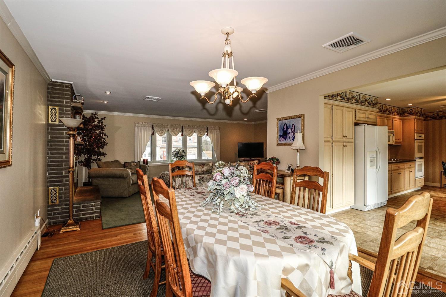147 Oxford Road Colonia, NJ 07067 - Photo 12 of 31 Sophisticated Formal Dining room for entertaining large gatherings with view of kitchen and Formal Living room bow window. Open floor plan.