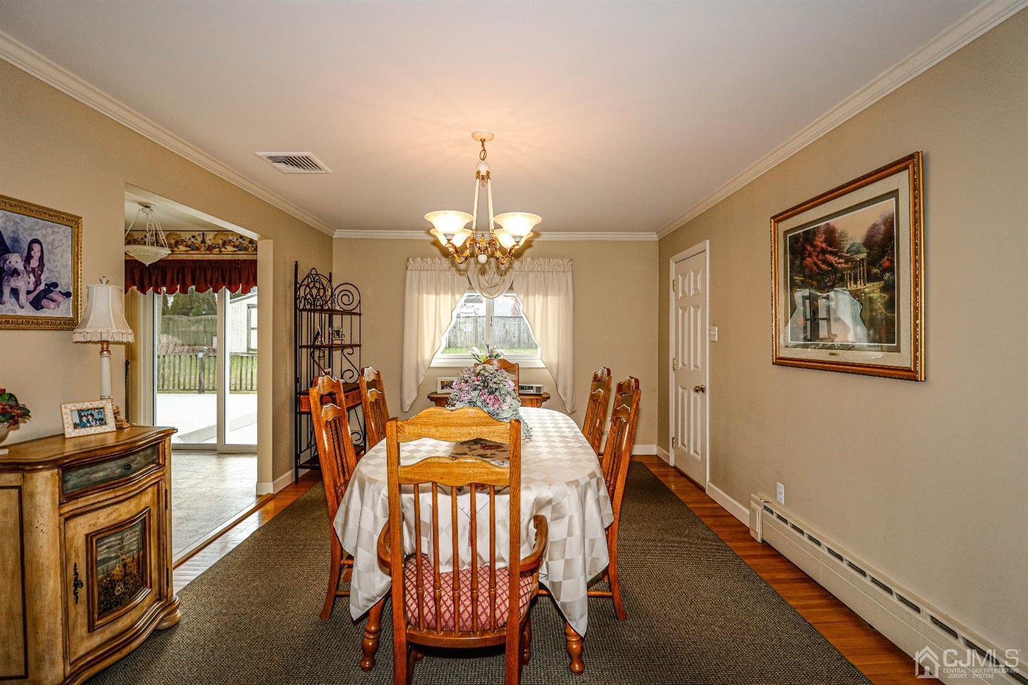 147 Oxford Road Colonia, NJ 07067 - Photo 13 of 31 Elegant Formal Dining room with hard wood floors and crown molding.