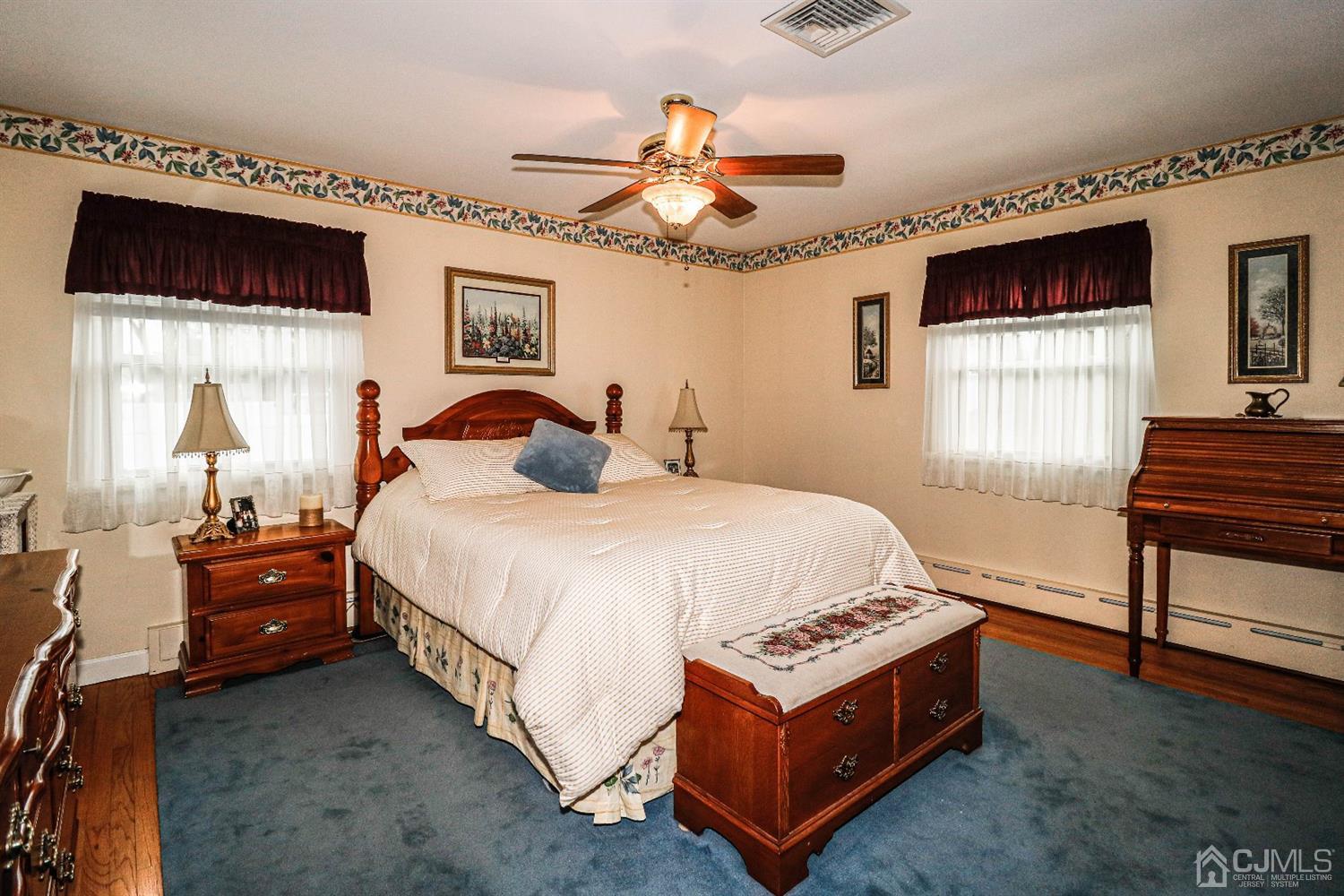 147 Oxford Road Colonia, NJ 07067 - Photo 16 of 31 Intimate master bedroom with walk in closet and master bath. Features hard wood floors, ceiling fan and two windows allowing brilliant light into this king size room.