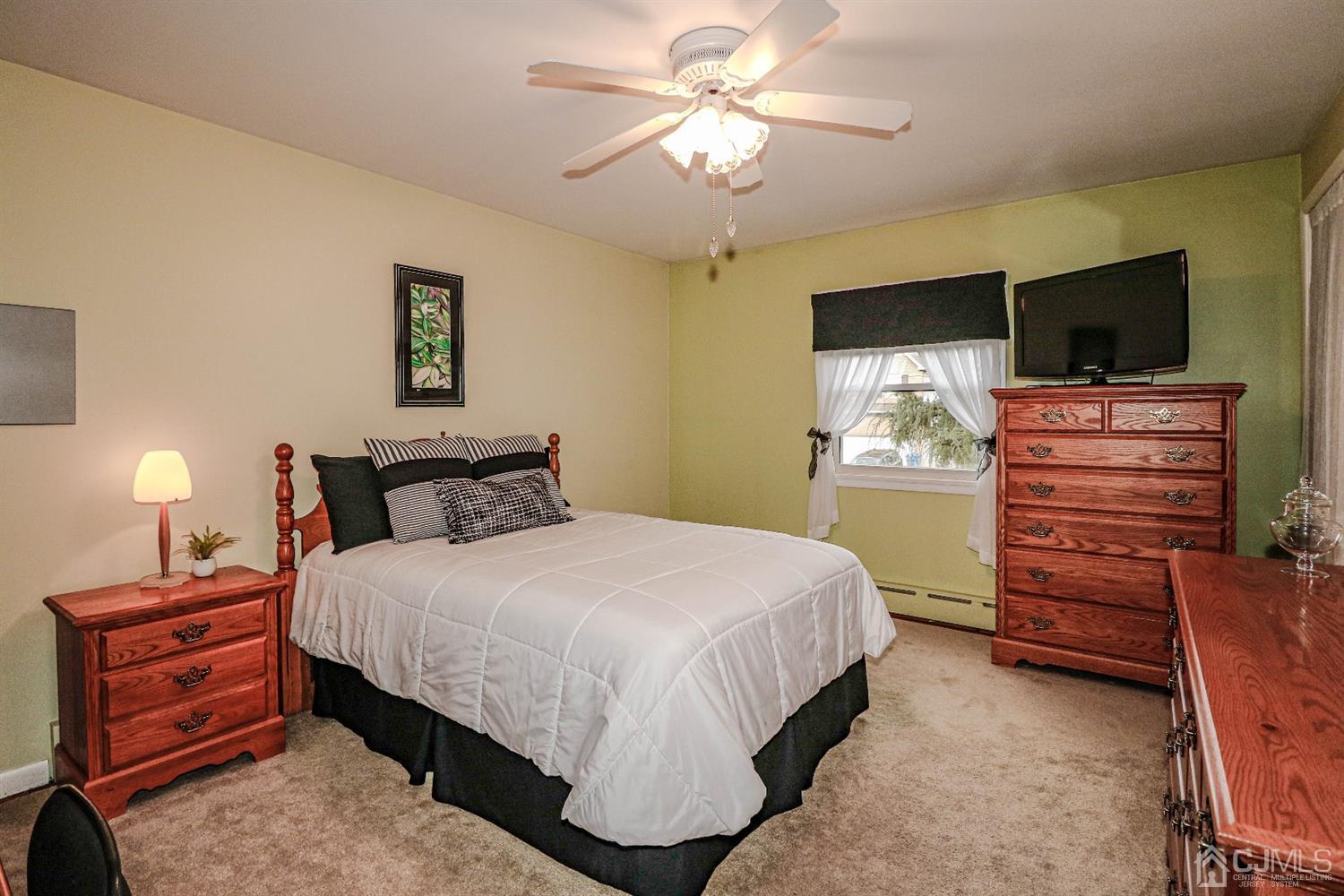 147 Oxford Road Colonia, NJ 07067 - Photo 20 of 31 Decorator's delight, great sized second bedroom with hard wood floors, double closet and ceiling fan.