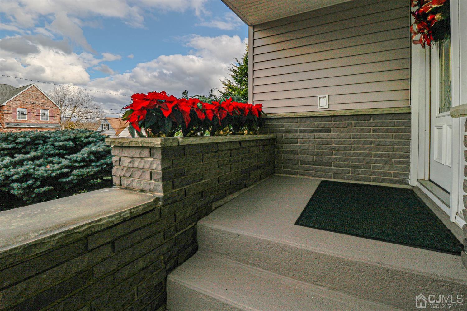 147 Oxford Road Colonia, NJ 07067 - Photo 3 of 31 Open front porch decorated in poinsettia plants as you approach the entrance of the upgraded well appointed home.