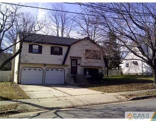 62 Meadow Road Edison, NJ 08817 - Photo 1 of 14 a front view of a house with a yard