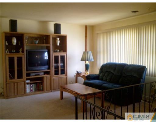 62 Meadow Road Edison, NJ 08817 - Photo 2 of 14 a living room with furniture and a flat screen tv