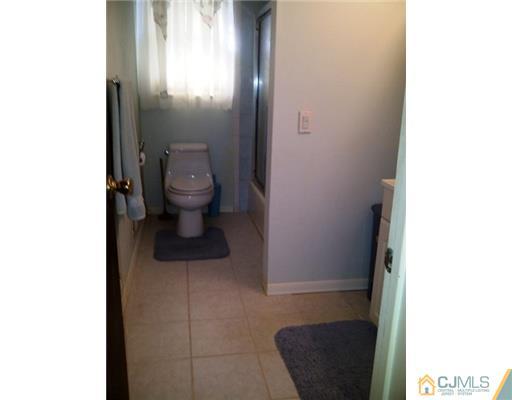 62 Meadow Road Edison, NJ 08817 - Photo 11 of 14 a bathroom with a toilet and a sink