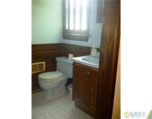 62 Meadow Road Edison, NJ 08817 - Photo 12 of 14 a bathroom with a toilet a sink and a window