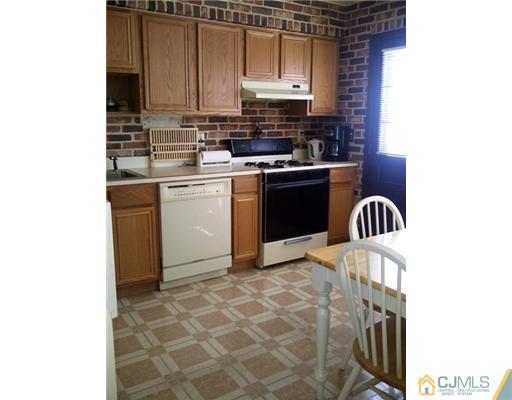 62 Meadow Road Edison, NJ 08817 - Photo 4 of 14 a kitchen with a sink cabinets and appliances