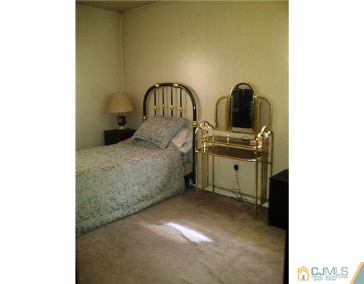 62 Meadow Road Edison, NJ 08817 - Photo 7 of 14 a bedroom with a bed and a cabinets