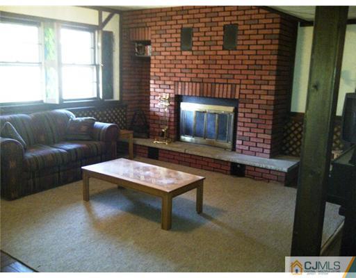 62 Meadow Road Edison, NJ 08817 - Photo 10 of 14 a living room with furniture a window and a fireplace