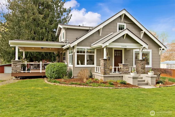 a front view of a house with a yard table and chairs